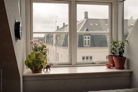 "Attic Window With View On Denmark Buildings" by Stocksy Contributor "Amor Burakova" - Stocksy