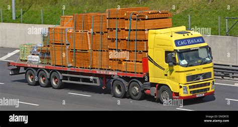 Haulage contractor truck and articulated trailer loaded with timber ...