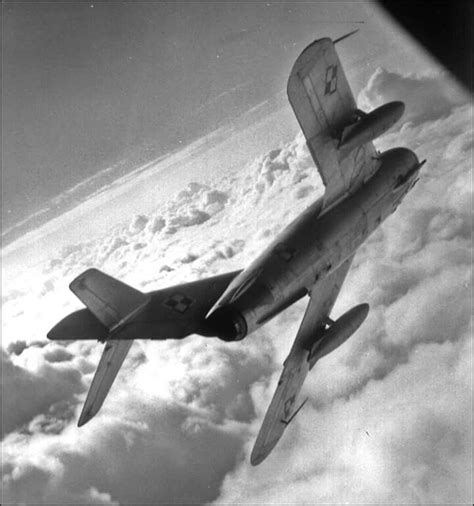 An Airplane Flying Above The Clouds In Black And White