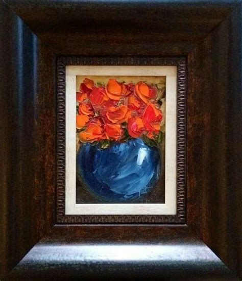 A Blue Vase With Orange Flowers In It