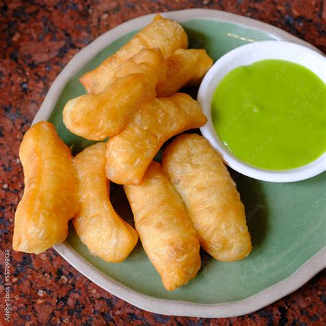 Deep Fried Dough Stick With Pandan Thai Custard On The Red Table Stock