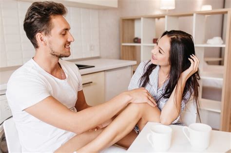 Free Photo Smiling Brunette Man Touching Womanfriend S Knee While She Playfully Posing In Kitchen