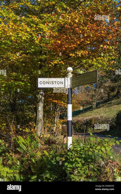 Coniston village signpost in the Lake district of Cumbria. Evening ...