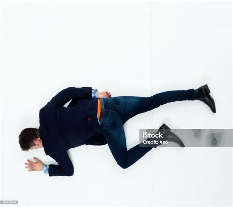 Handsome Businessman Knocked Out And Lying On Floor Stock Photo