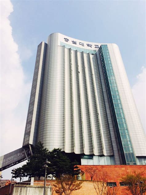 A Very Tall Building Sitting Next To A Parking Lot