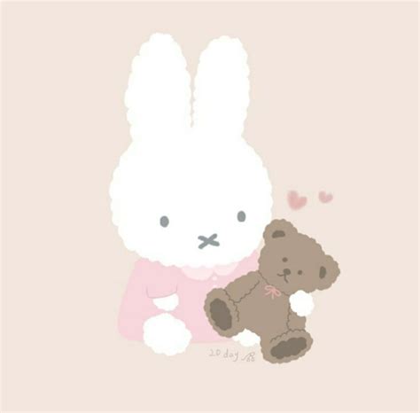 A White Rabbit And A Brown Teddy Bear Sitting Next To Each Other On A