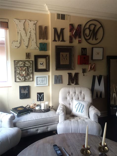 A Living Room Filled With White Furniture And Lots Of Framed Letters On