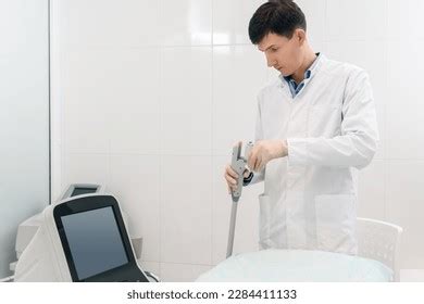 Professional Male Beautician Preparing Modern Ultrasonic Stock Photo