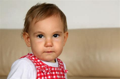 Premium Photo Baby Looking With Huge Eyes Into Camera