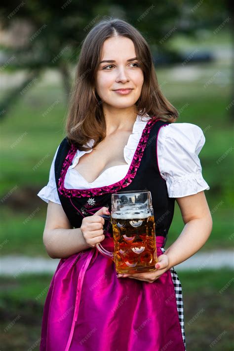 Premium Photo Sexy Russian Woman In Bavarian Dress Holding Beer Mugs