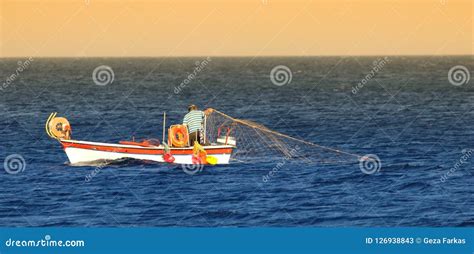 Greek Fishermen Fishing With Net On The Boat Editorial Stock Photo