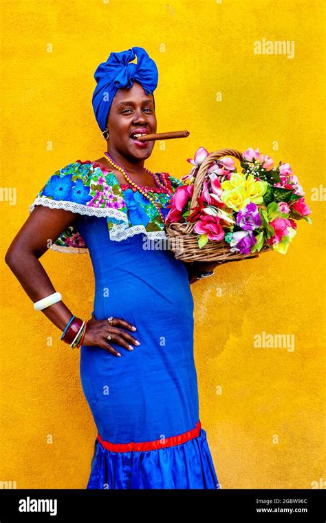 A Young Cuban Woman In Traditional Dress Poses For A Photo In The Old ...