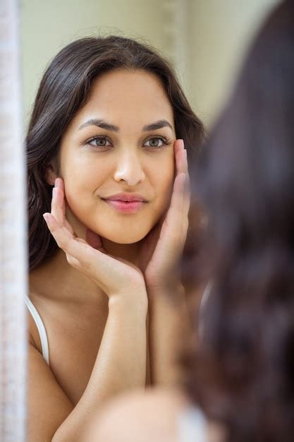 Premium Photo Young Woman Looking In Mirror Of Bathroom