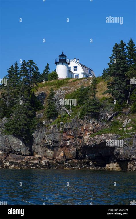 Bear Island Lighthouse Sits Atop Rocky Cliffs Surrounded By Evergreen