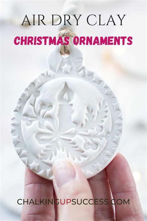 A Hand Holding An Air Dry Clay Ornament With The Words Christmas