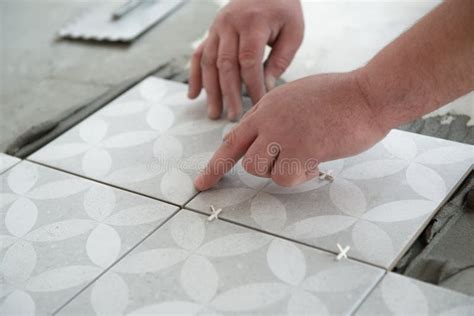 Tiler Laying The Ceramic Tile On The Floor Professional Worker Makes