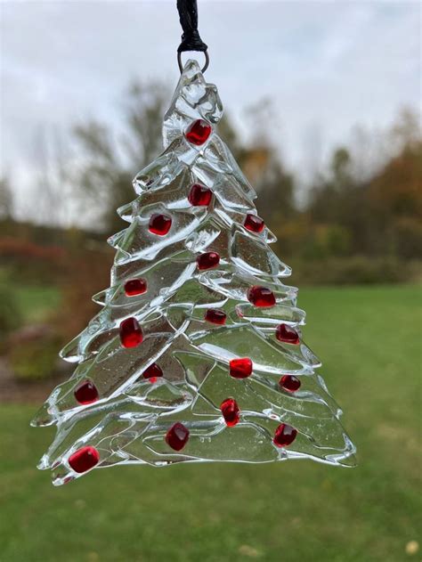 A Glass Christmas Tree Ornament Hanging From A String