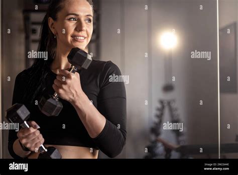 Portrait Happy Athletic Brunette Woman Posing At Mirror Holding Dumbbells Smiling Healthy
