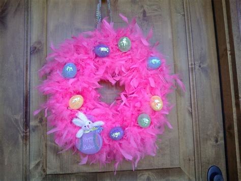 A Pink Wreath With Some Decorations On It