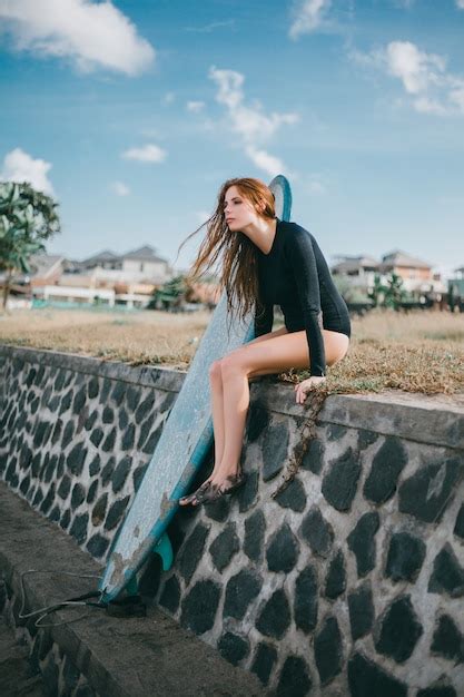 Free Photo Young Beautiful Girl Posing On The Beach With A Surfboard