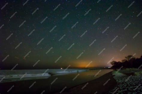 Premium Photo | Night sky with stars and sand beach