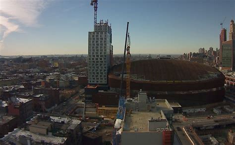 tower rises  facade problems remain arena green roof