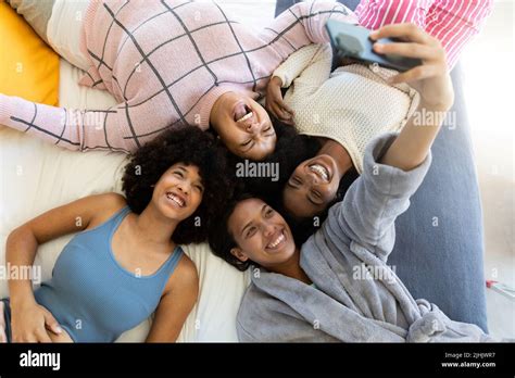 High Angle View Of Biracial Woman Taking Selfie Over Cellphone With