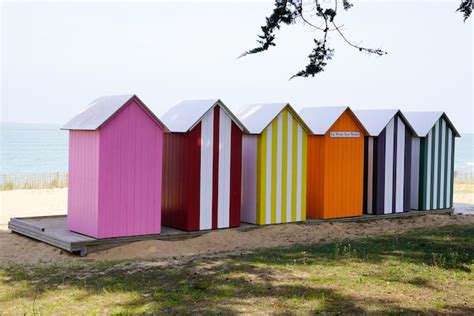 Premium Photo Row Of Colorful Wooden Beach Huts On The Beach In