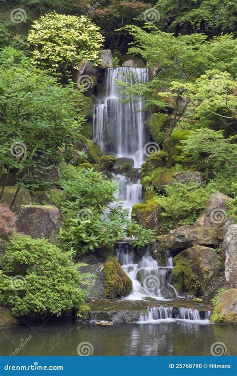 Cascading Waterfall Surrounded By Lush Greenery Royalty Free Stock