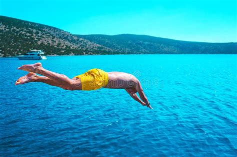 Young Man Diving into the Turquoise Water of the Sea from Yacht . Stock ...