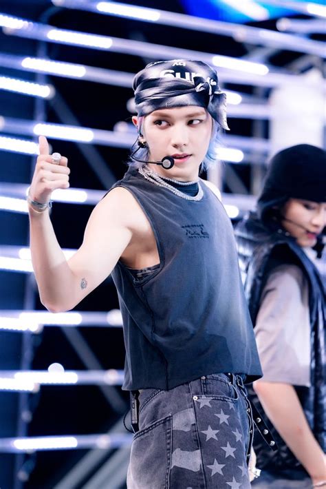 A Male Model In A Black Shirt And Bandana On The Catwalk At A Fashion Show