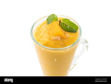 fresh mango smoothie on white background Stock Photo - Alamy