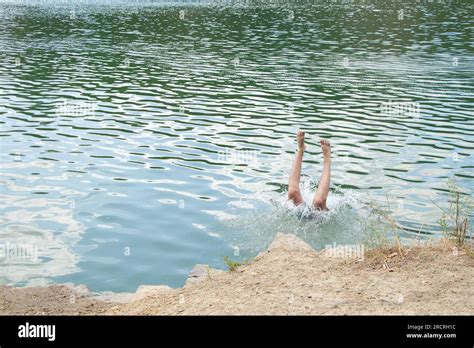 Men S Legs Stick Out Of The Water In A Quarry In Ukraine During