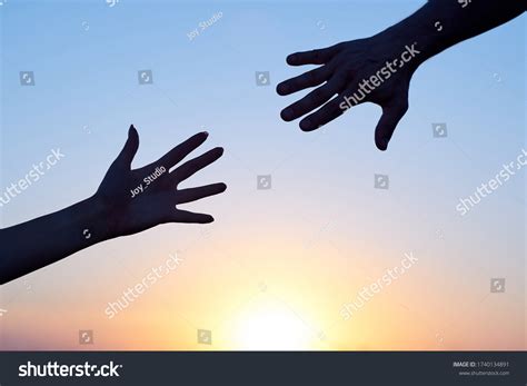 Two Hands Reaching Out To Each Other