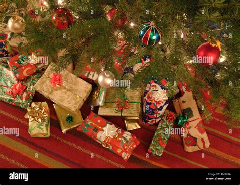 Wrapped Christmas presents under the tree Stock Photo - Alamy