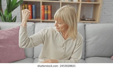Blonde Woman Flexing Her Arm Muscles Stock Photo 2453028821 Shutterstock