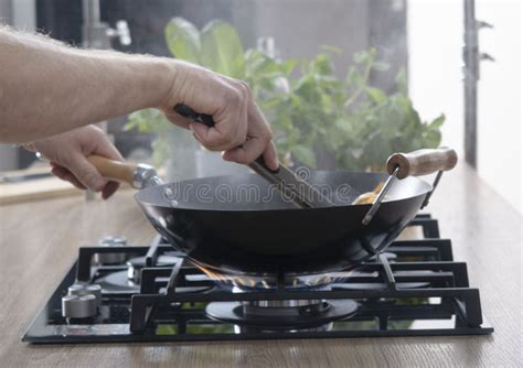 Frying Pan On A Gas Stove Chef Controls The Cooking Process Stock