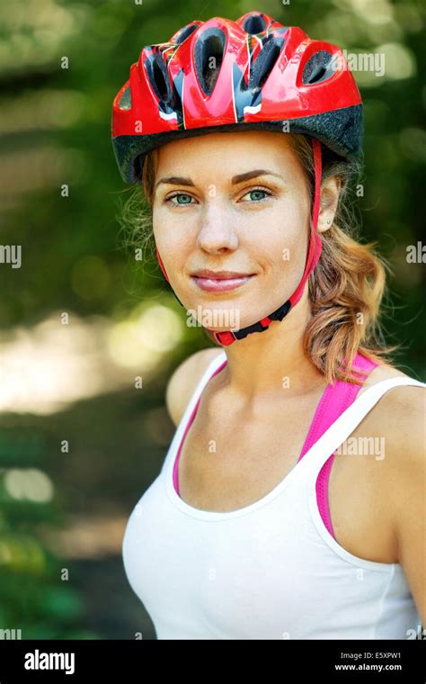 Portrait of happy young cyclist in sport clothes and helmet Stock Photo - Alamy