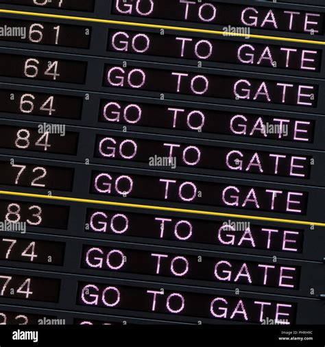 Airport departure board with go to gate sign Stock Photo - Alamy