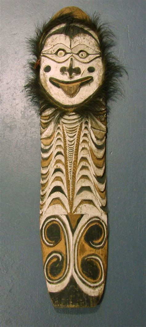 A Sepik River Ancestral Hardwood Shield Finely Incised And Decorated With Natural Ochres And