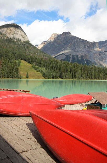 Premium Photo Red Boat Moored In Lake Against Mountains