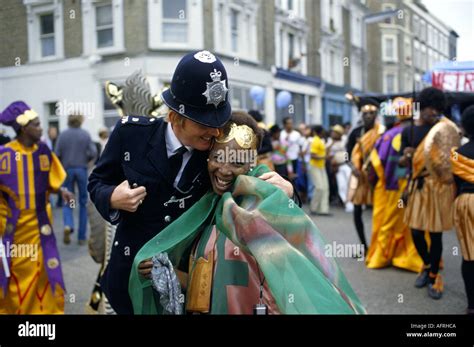 Notting Hill Carnival London Policeman And Partygoers In Costumes