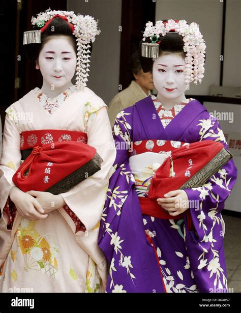 Geisha In Traditional Make Up And Wearing A Kimono In The Gion District