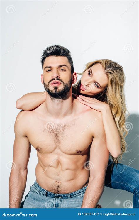 Shirtless Bearded Man Looking At Camera Near Attractive Blonde Woman On White Stock Image