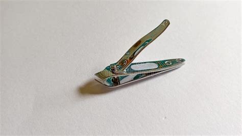 Elegant Steel Nail Clippers With A Pointed Tip Placed On A Clean White