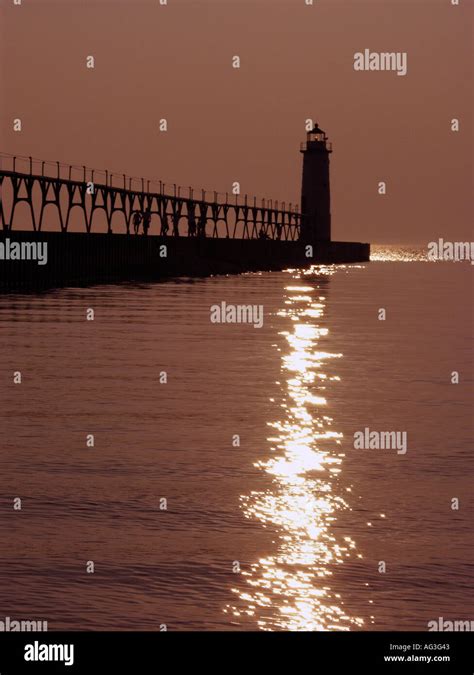 Sunset behind the lighthouse on Lake Michigan at Manistee Michigan ...