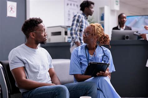 Free Photo Female Nurse Doing Consultation With Patient Taking Notes On Digital Tablet And