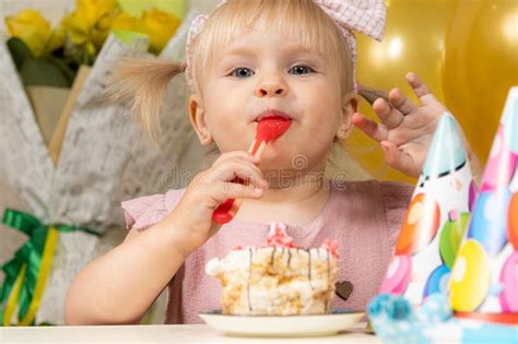 Two Year Old Blonde Girl Eating Birthday Cake On Her Birthday Stock Photo Image Of Surprise
