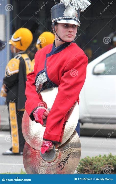 Young White Female Cymbal Player In A Marching Band In The Cherry