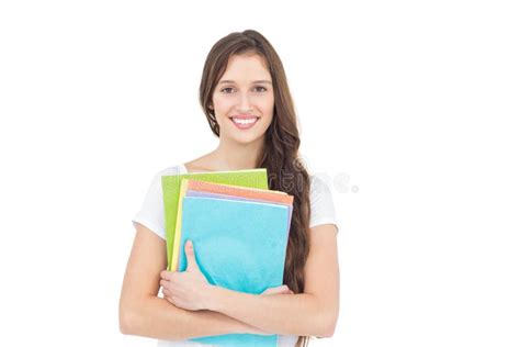 College Boy Holding Books With Blurred Students In Park Stock Photo